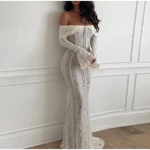 Close-up of elegant white lace dress showing off-shoulder neckline and intricate floral patterns