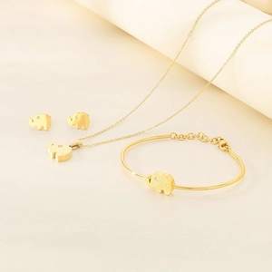 Detailed set of gold plated elephant jewelry featuring crystal eyes on necklace and earrings