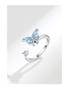 Close-up of butterfly fidget ring featuring blue crystals and silver adjustable band
