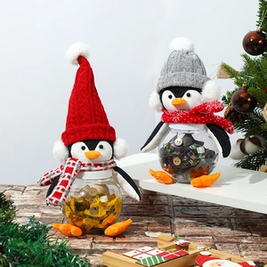 Christmas penguin candy jars with knit hats and red scarves for holiday table decoration