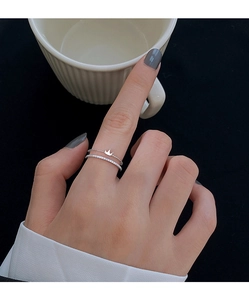 Detail of silver crown double layer ring with fine zircon stones on model hand
