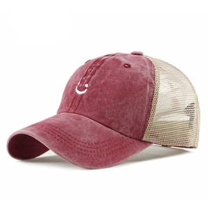 Vintage washed red baseball mesh cap with embroidered smiley face and curved brim