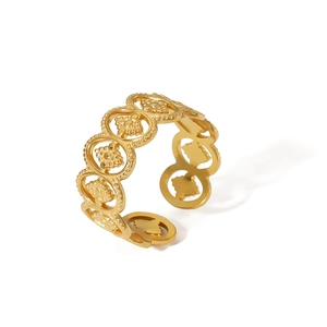 Detail of vintage 18k gold plated stainless steel ring with hollow floral pattern