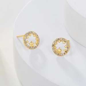 Detail of gold-plated hoop earrings with micro-set zircon and hollow star patterns