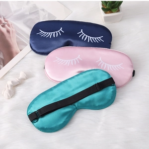 Detailed view of silk sleep eye masks with eyelash print and adjustable elastic straps