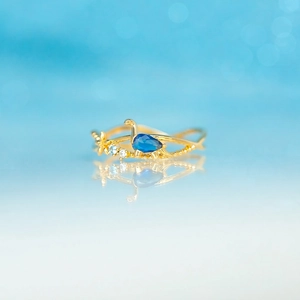 Cute 18K gold dinosaur ring with blue pear gemstone and sparkling crystals for women