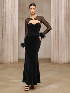Elegant black velvet evening gown with sheer mesh top and feather cuffs on sleeves