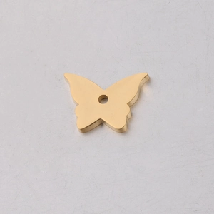 Close-up of golden stainless steel hollow butterfly pendant for DIY jewelry making