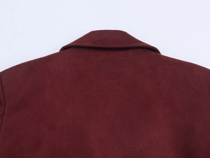 Close-up of back collar stitching on deep red faux suede jacket with velvet texture