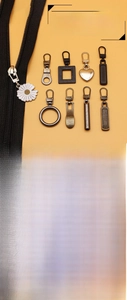 Macro shot of detachable metal zipper heads in daisy and heart shapes with alloy finish