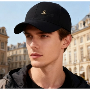 Outdoor shot of men's black baseball cap with golden S embroidery and curved visor