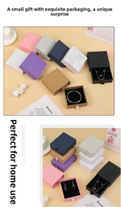 Close-up of sliding drawer jewelry boxes in various colors with ribbon pull tabs