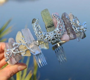 Close-up of handmade crystal cat ear crown with moon pendant and metal hair comb