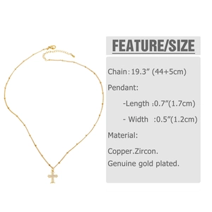 Close-up of gold cross pendant with cubic zirconia detailing and product dimensions