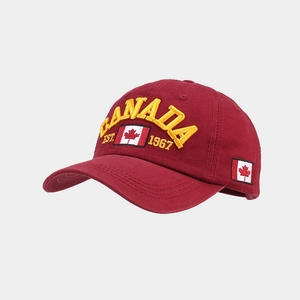 Detailed view of yellow 3D Canada embroidery and flag on burgundy cotton baseball cap
