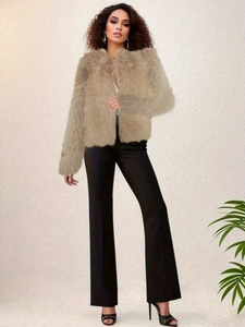 Detail of apricot faux fur short jacket with round neck and long sleeves on a model