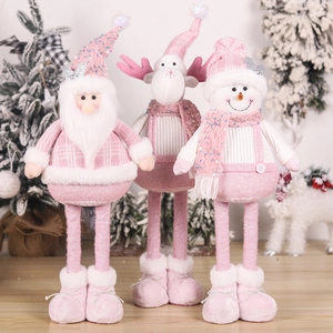 Detail of pink and white plush Christmas ornaments including Santa, reindeer and snowman