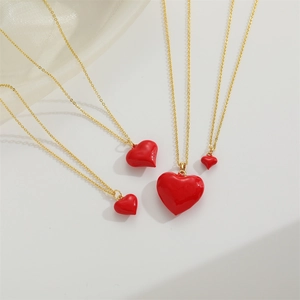 Fashionable golden necklaces featuring red enamel heart pendants in various sizes