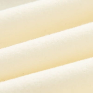 Macro shot of soft creamy white wool fabric with thick faux fur texture and fine fibers