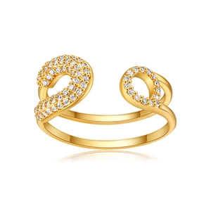 Macro detail of gold-plated zircon bow ring showing high-polish finish and sparkling crystals