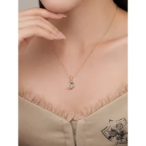 Elegant 925 sterling silver croissant necklace with blue stone on a female model