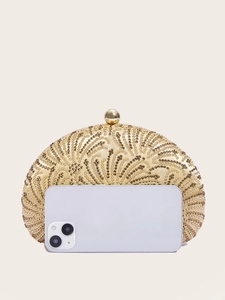 Detail of gold shell evening bag with rhinestone waves next to a smartphone