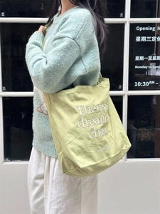 Light green canvas tote bag with embroidered letters and large capacity for women