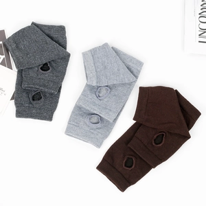 Close-up of knitted fingerless arm warmers in grey and coffee with thumb hole design