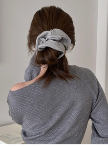 Detail of grey striped fabric scrunchie shown on a ponytail for a soft, aesthetic look