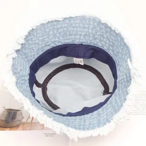 Light blue denim bucket hat with white frayed edges and internal 100% cotton sweatband