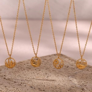 Detail of four gold city landmark necklaces with intricate architecture and crystals