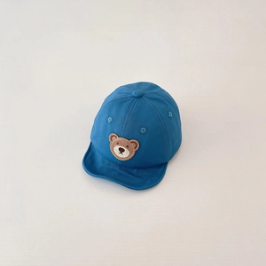 Close-up of navy blue baby baseball cap with brown bear embroidery and soft cotton brim