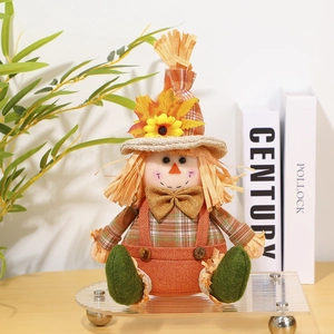 Detail of harvest gnome doll with sunflower hat, plaid overalls and straw accents