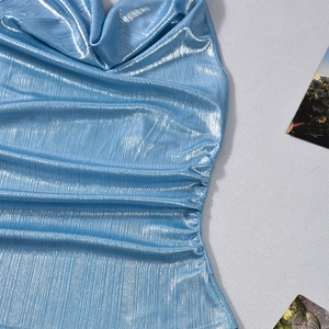 Detailed close-up of glossy blue metallic cowl neck top with shimmering vertical texture