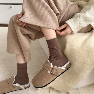 Women's brown suede clog with cozy fleece lining and side metal buckle on knit socks