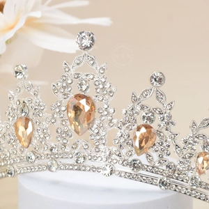 Macro shot of silver crown with champagne teardrop stone and crystal details
