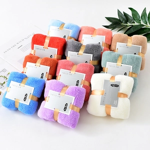 Thick coral fleece towels in multi-color sets with minimalist gift packaging on white background