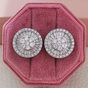 Macro view of silver floral stud earrings with zircon inlay in a velvet jewelry box