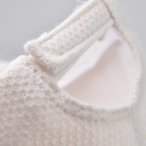 Macro shot of adjustable strap detail on cream white mesh baseball cap with scorpion embroidery