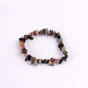 Detailed macro view of colorful natural stone chips on an elastic handmade bracelet