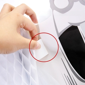 Close-up of Halloween paper ghost assembly showing card insertion into the honeycomb slot