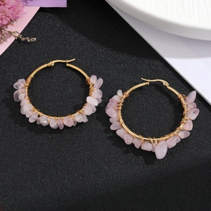 Handmade gold hoop earrings with pink natural stones in a bohemian style for women
