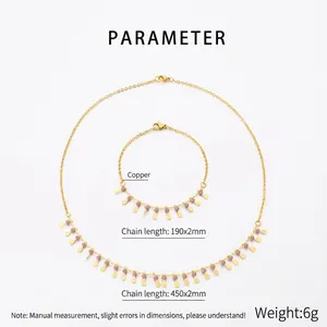 Macro detail of golden jewelry set with copper chains and pink beaded teardrop charms