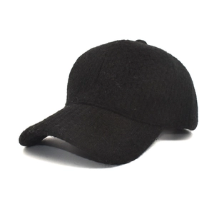 Detailed close-up of a black textured wool-blend baseball cap with curved brim for winter