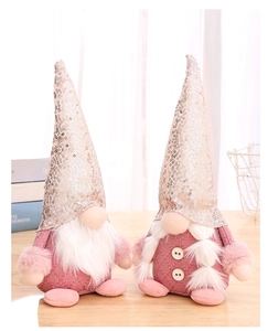 Close-up of pink sequined gnome dolls with plush beards on a wooden surface