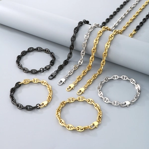 Close-up of stainless steel anchor chain jewelry set in gold, silver and black finishes