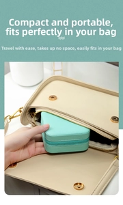Compact mint green travel jewelry box being placed in a bag to show its portable size