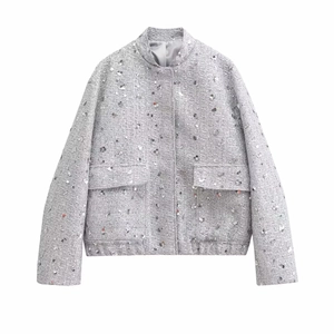 Detailed view of silver sequin tweed jacket with stand collar and front pockets
