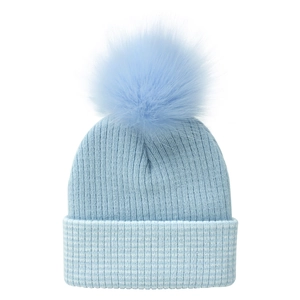 Detail of light blue ribbed knit beanie with large fluffy faux fur pom pom for kids