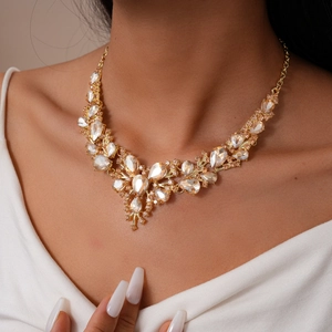 Macro view of vintage champagne rhinestone floral necklace on model for formal events